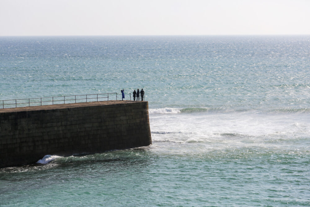 Porthleven pier - people standing on pier